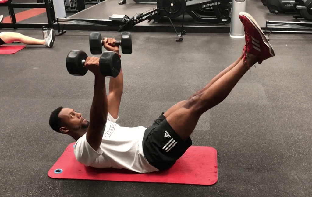 The hollow hold dumbbell press targets your mid section and the core area